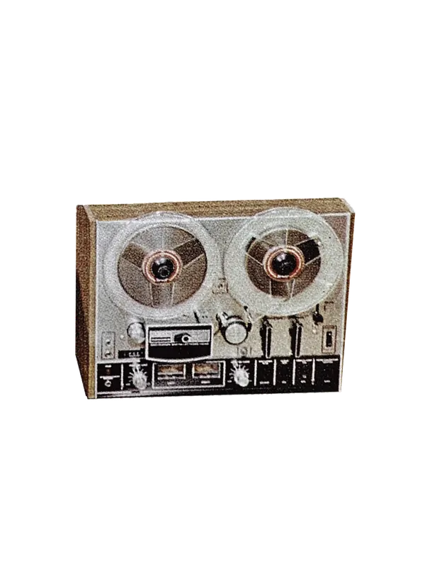 A reel-to-reel tape machine growing roots and flowers